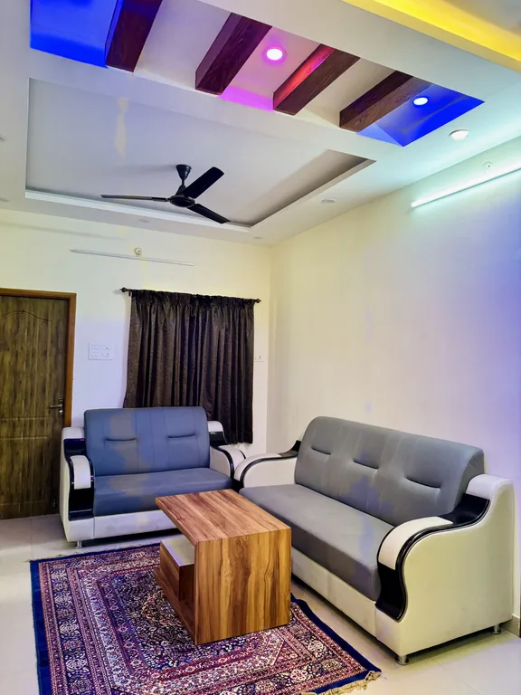 Living room with sofa and coffee table in the Two Bedroom Apartment with Balcony and Terrace at Marvee Luxus Stays, Ram Nagar, Coimbatore